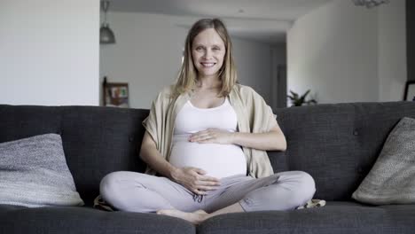 Front-view-of-pregnant-woman-massaging-belly
